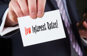 person holding sign with low interest rate